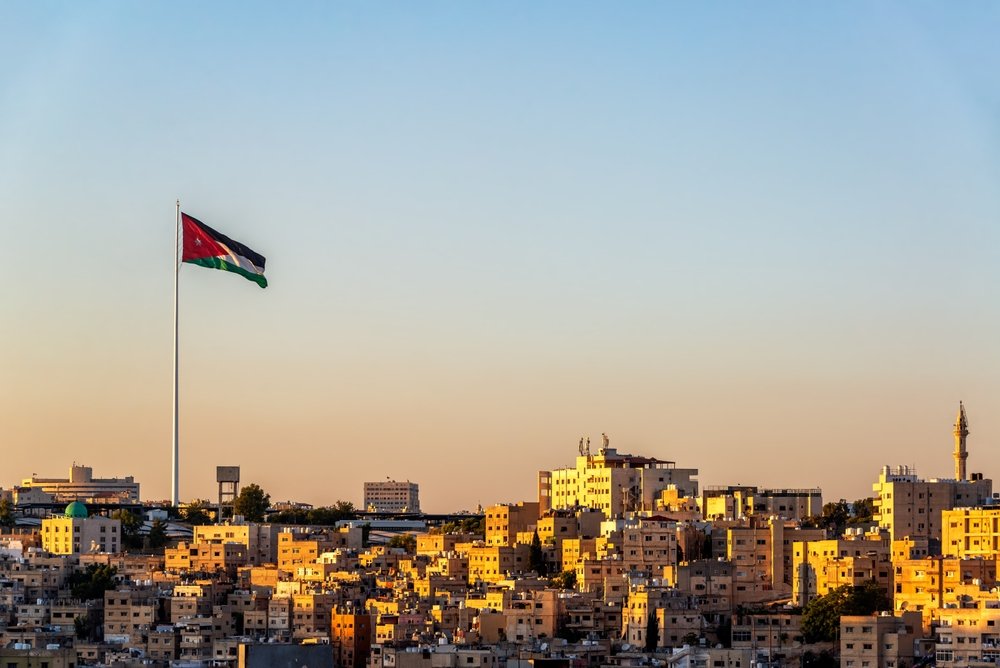 Beautiful,Sunset,Cityscape,Of,Amman,,Jordan,With,Jordanian,Flag,Flying